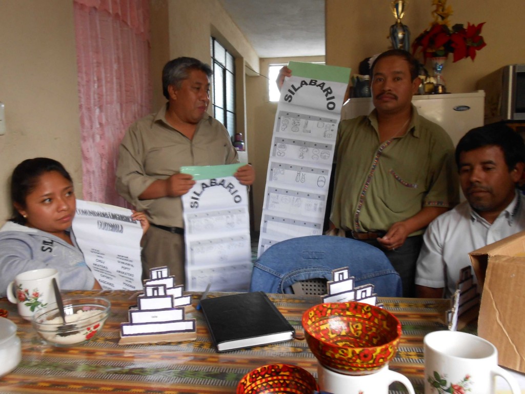 The Coban team has developed its own teaching materials, including this unique presentation of the hieroglyphic syllabary (from left to right: Yudy Mo’, Mario Caal, Augusto Tul Rax, and Leonel Pacay Rax).