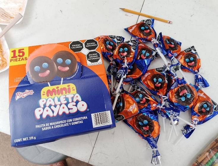 A box of candy and a pencil

Description automatically generated