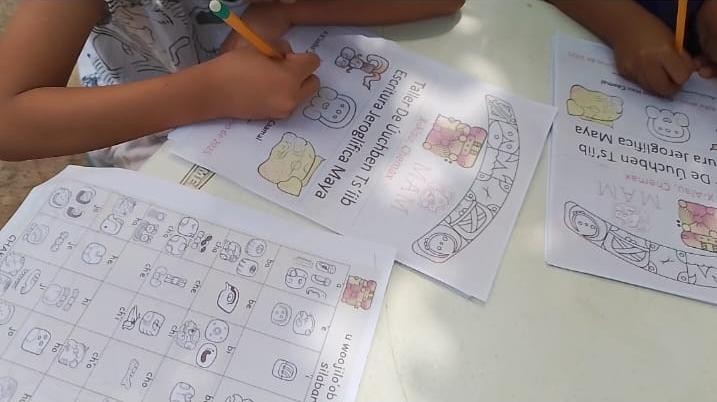 A child writing on a piece of paper

Description automatically generated