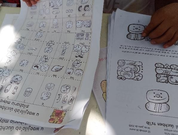 A close-up of a person's hands holding a paper

Description automatically generated