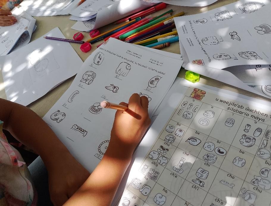 A person drawing on a piece of paper

Description automatically generated