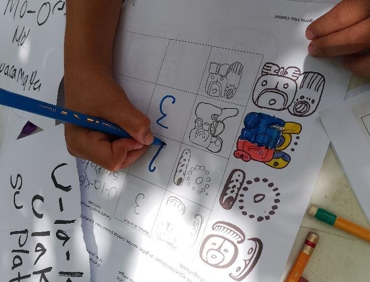 A person drawing on a piece of paper

Description automatically generated