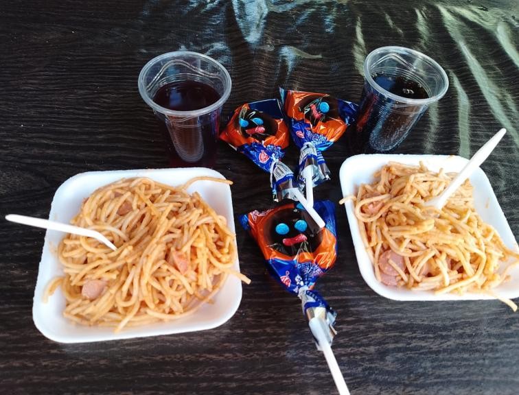 A plate of food and candy

Description automatically generated