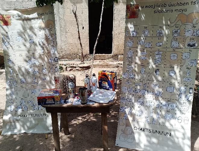 A table with signs and drinks on it

Description automatically generated