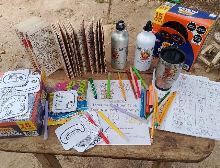 A table with various coloring books and pencils

Description automatically generated